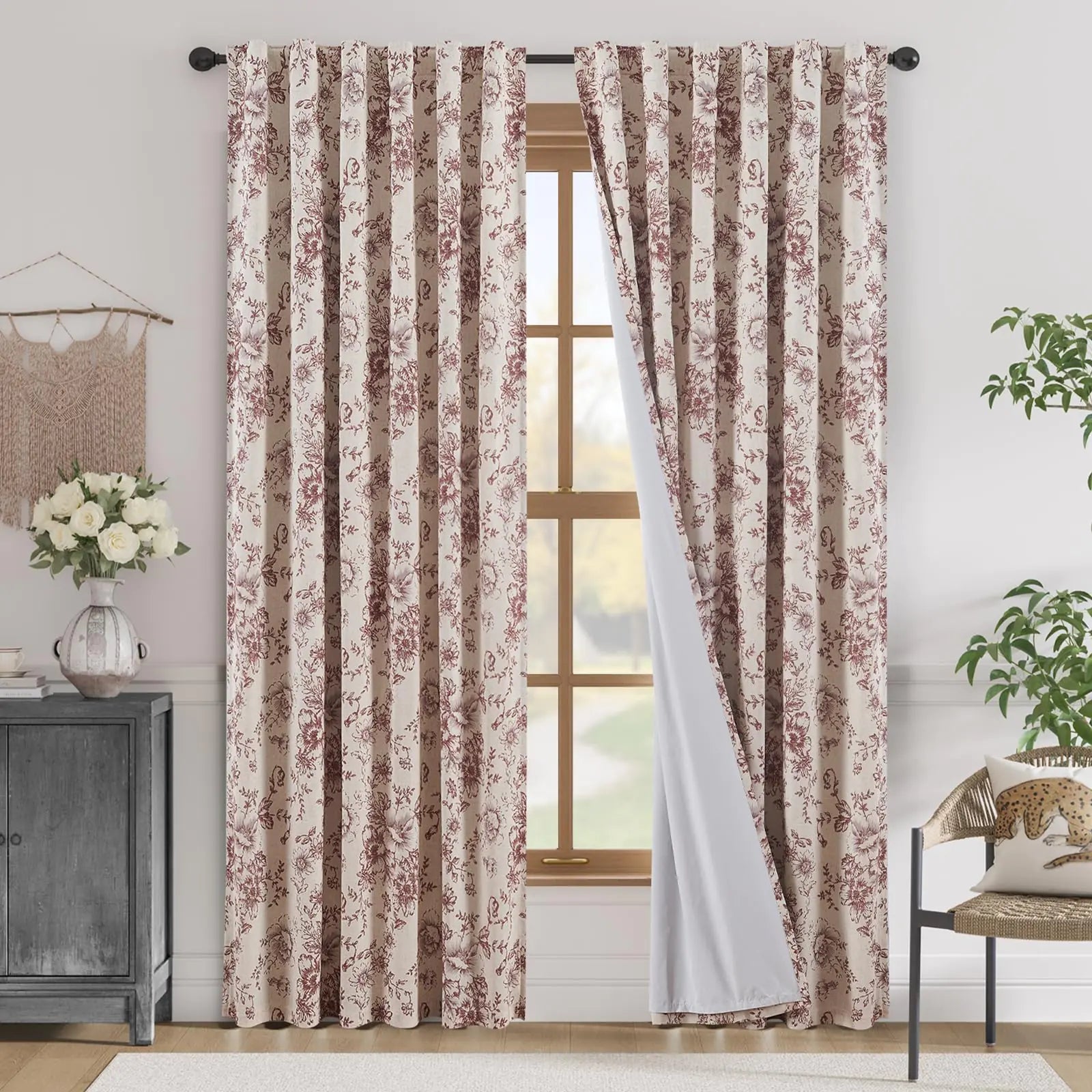 Floral patterned blackout linen blend curtains hanging on a window in a bright, modern living room