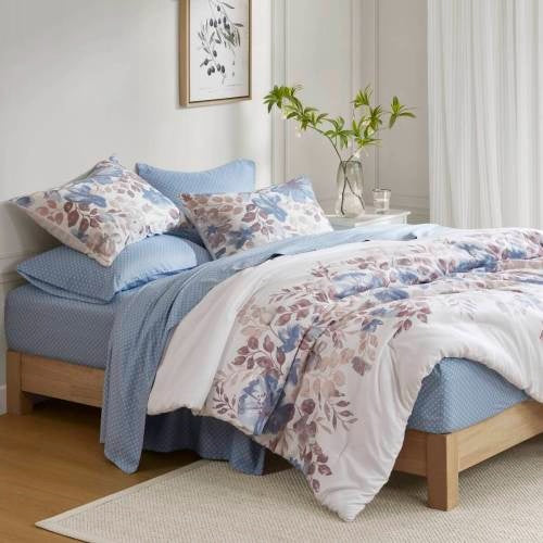 Shopi Vella blue floral comforter set queen with matching pillow shams on wooden bed frame