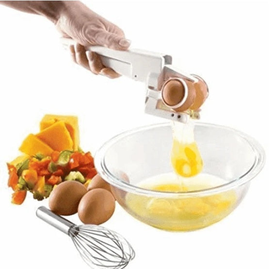 Creative egg shell separator in use cracking egg over glass bowl with kitchen vegetables and whisk nearby