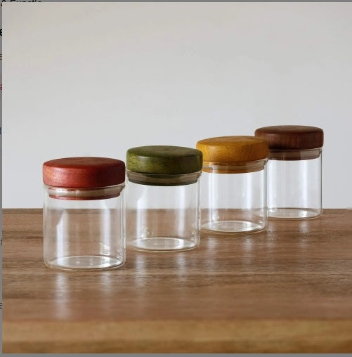 Shopi Vella kitchen canister set for pantry organization with four clear glass jars and colored wooden lids