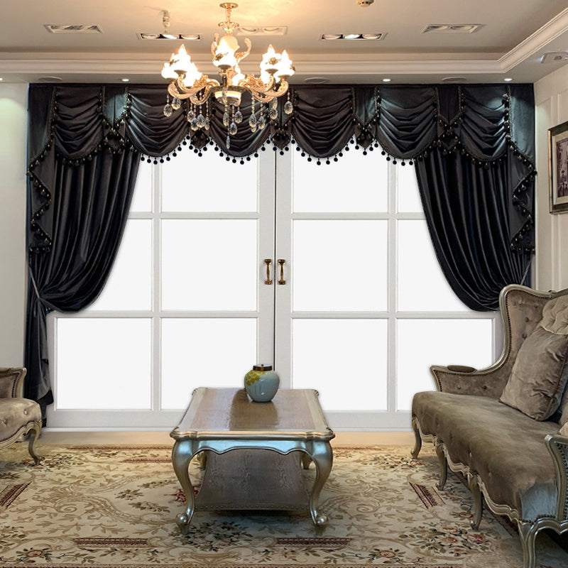 Shopi Vella luxury black velvet curtains with elegant tassels in a classic living room setting