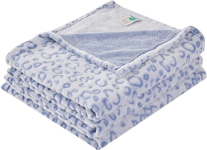 Shopi Vella super soft women's blanket in light blue with leopard print pattern folded neatly