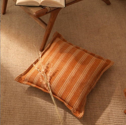 Shopi Vella 20x20 decorative pillow for sofa with orange and beige striped pillow case on carpet