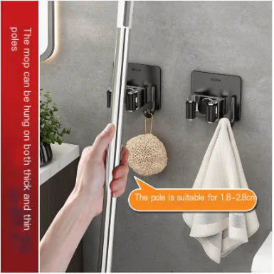 304 stainless steel mop holder mounted on wall holding mop and towel in bathroom