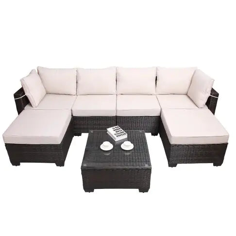 7 piece outdoor patio furniture set with dark wicker frame and light beige cushions including sectional sofa and coffee table