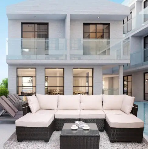 7 piece outdoor patio furniture set with beige cushions and dark wicker frame on a patio