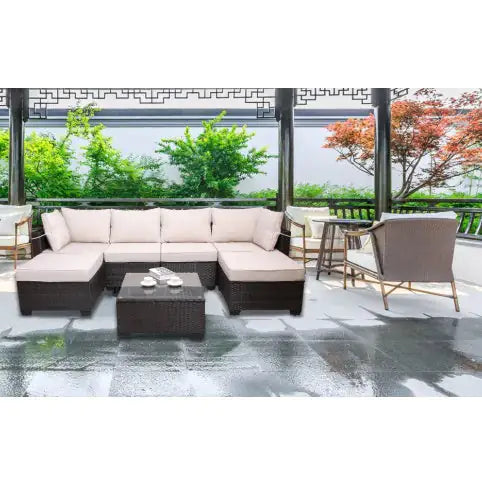 7 piece outdoor patio furniture set with beige cushions and dark wicker frame under covered pergola
