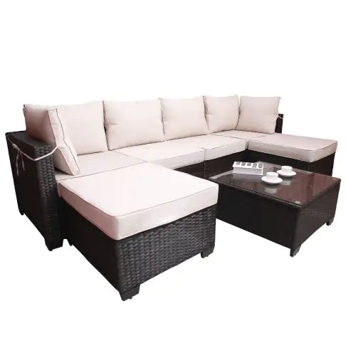 7 piece outdoor patio furniture set with dark wicker frame and beige cushions including sofa and coffee table