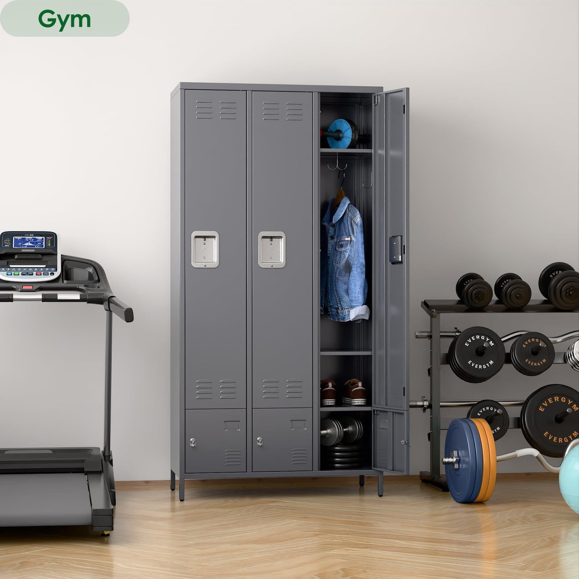 Shopi Vella metal storage locker with doors in gray placed in a gym with hanging clothes and workout equipment