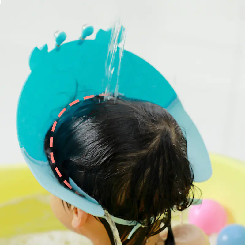 Blue adjustable baby shower cap protecting baby's eyes and face from water during bath time