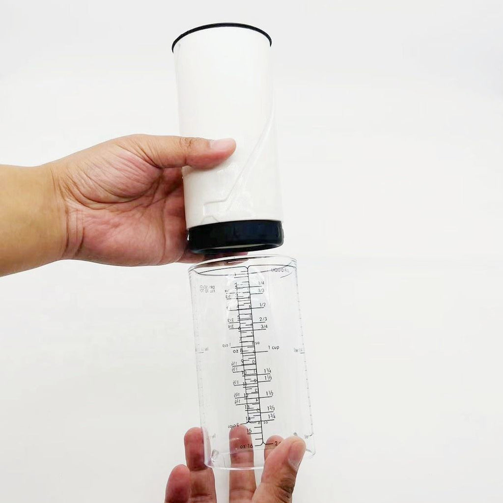 Shopi Vella adjustable rotating measuring cup with clear marked measurements and white top held by hands