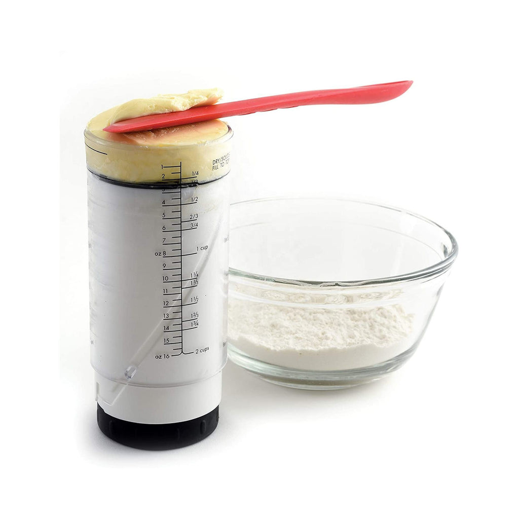 Shopi Vella adjustable rotating measuring cup with dough and red spatula next to a glass bowl of flour