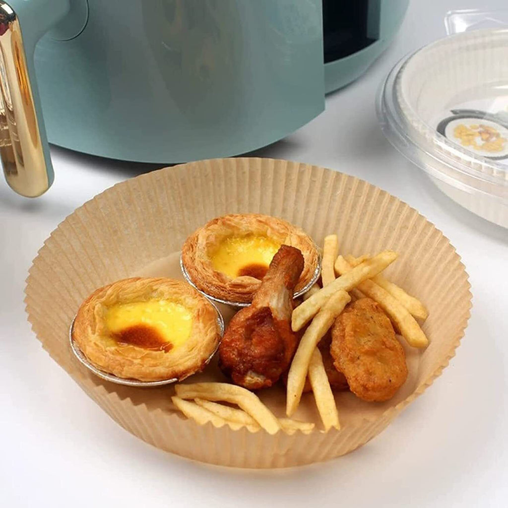 Shopi Vella air fryer disposable liners holding fried chicken wings, french fries, and egg tarts
