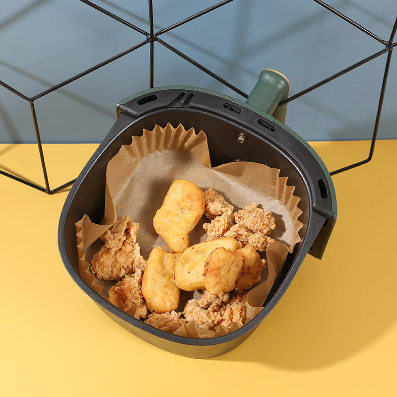 Shopi Vella air fryer disposable paper liners with fried chicken and nuggets in black air fryer basket