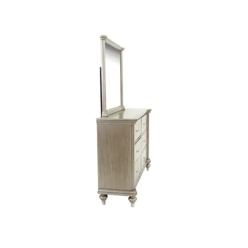 Side view of antique champagne finish bedroom furniture dresser with attached mirror and multiple drawers