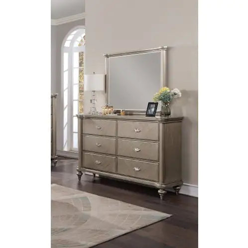 Antique champagne finish bedroom furniture dresser with six drawers and matching mirror in elegant room