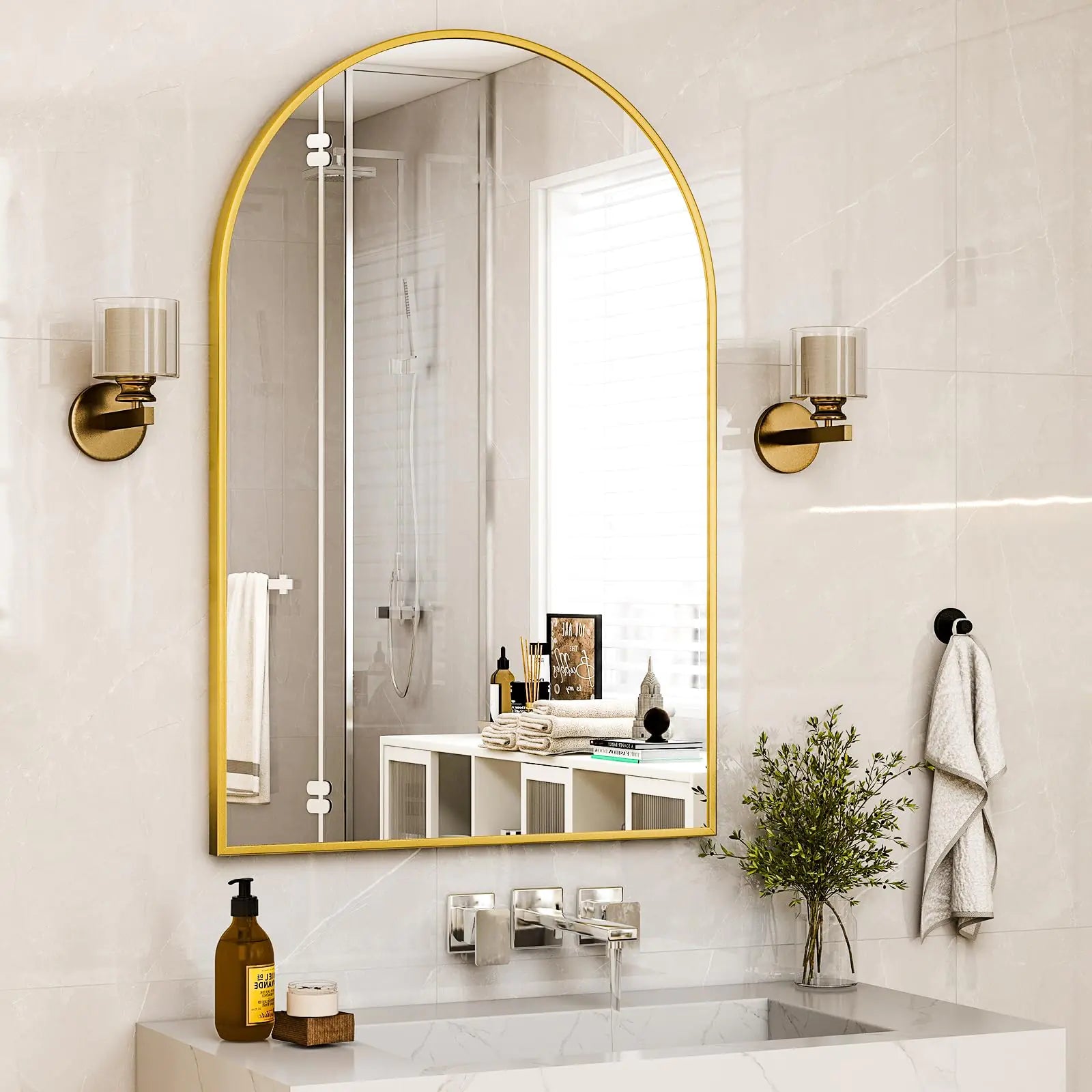 Elegant arched bathroom mirror gold frame mounted above white sink with modern fixtures
