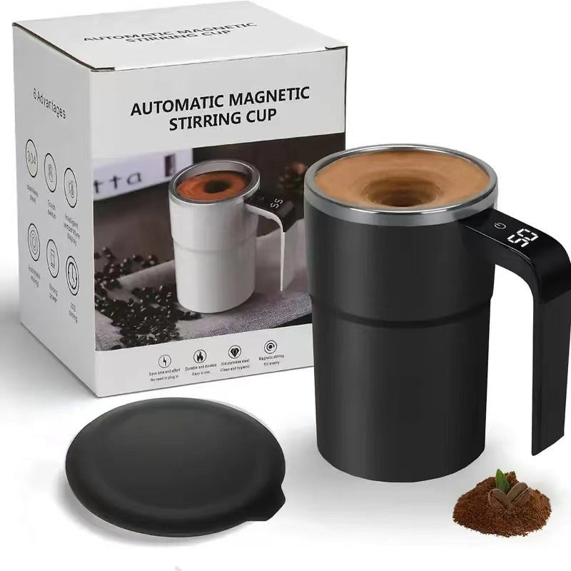 Shopi Vella automatic coffee stirring cup in black with digital display and black lid beside coffee grounds