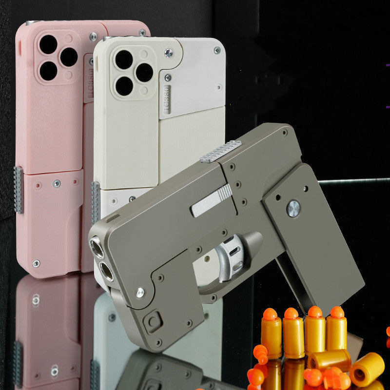Automatic shell throwing toy pistol with realistic design displayed alongside two phone cases for home storage by Shopi Vella