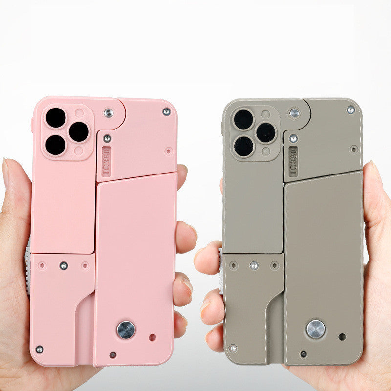 Two phone cases in pink and gray designed as automatic shell throwing toy pistol held in hands
