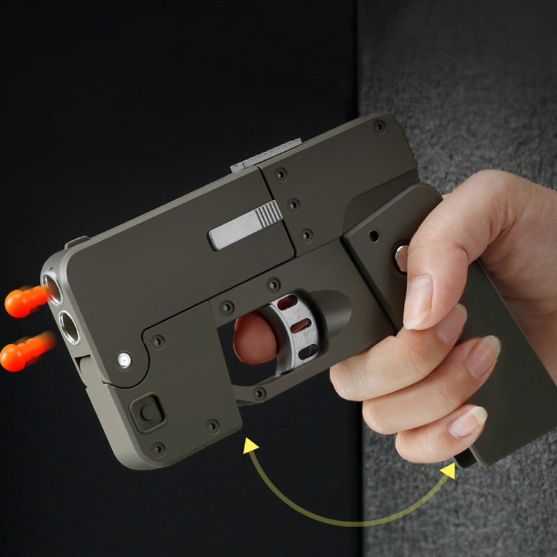 Shopi Vella automatic shell throwing toy pistol held in hand with orange tips and trigger detail