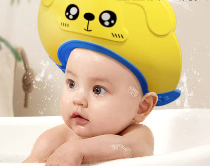 Baby wearing yellow baby shampoo cap waterproof with cute animal design during bath time