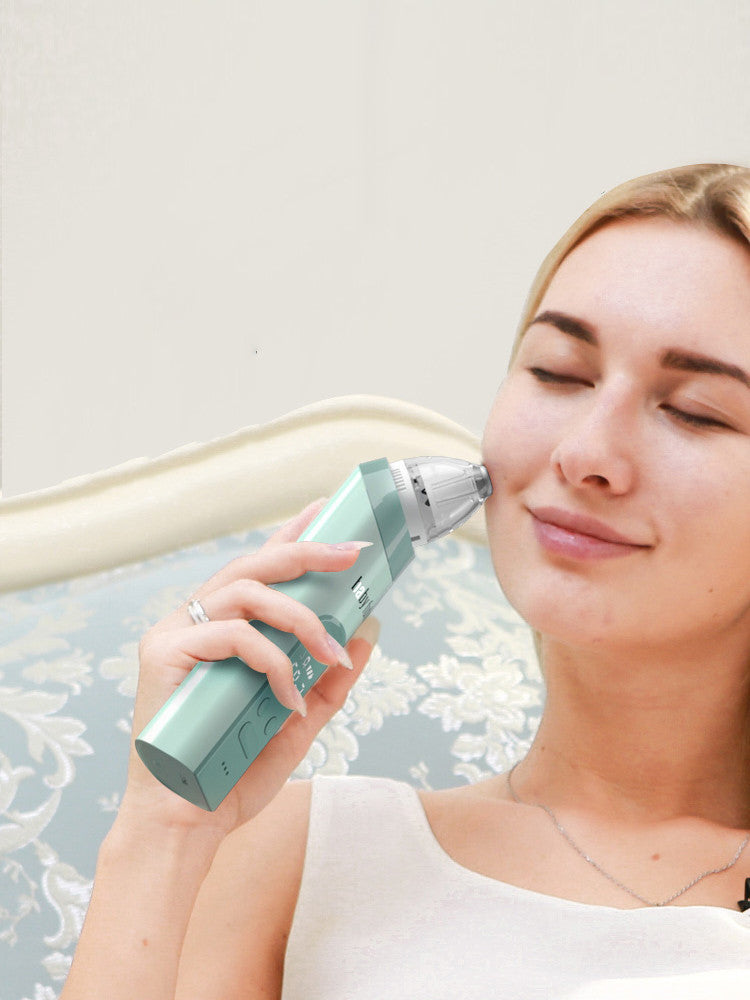 Woman using a Shopi Vella electric nasal aspirator for babies with a mint green design
