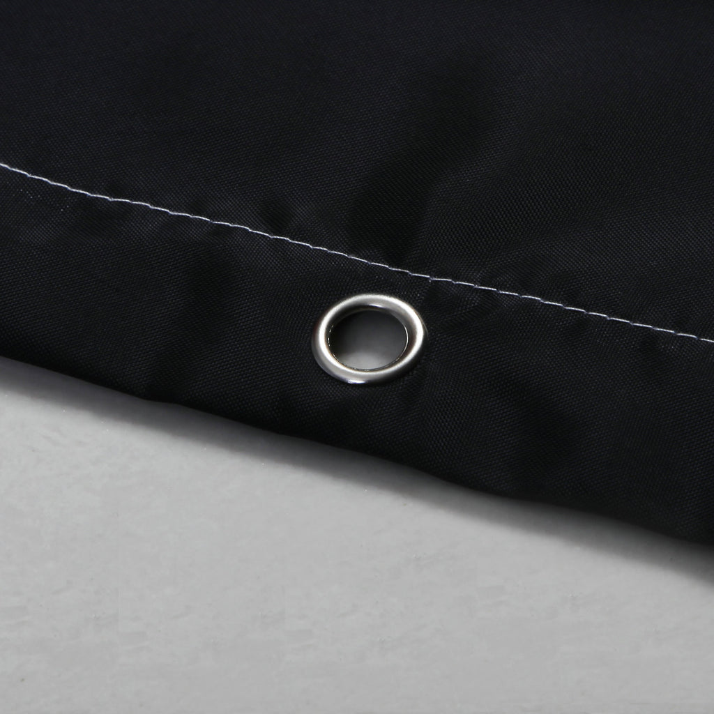 Close-up of black waterproof shower curtain corner with metal grommet and white stitching