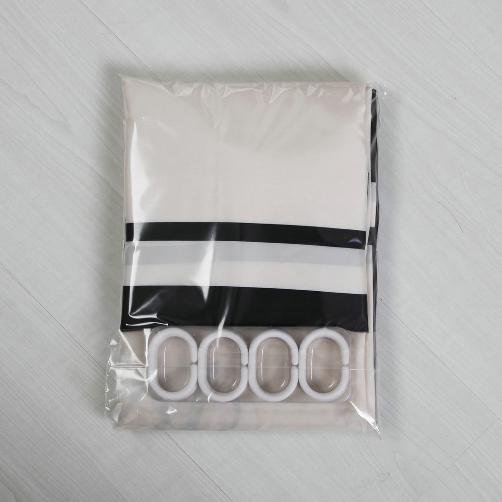 Shopi Vella waterproof shower curtain in black and white stripes with white hooks in clear packaging