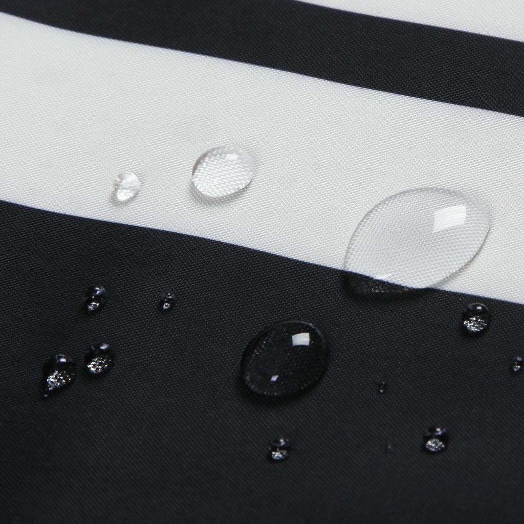 Close-up of waterproof shower curtain fabric with water droplets on black and white stripes