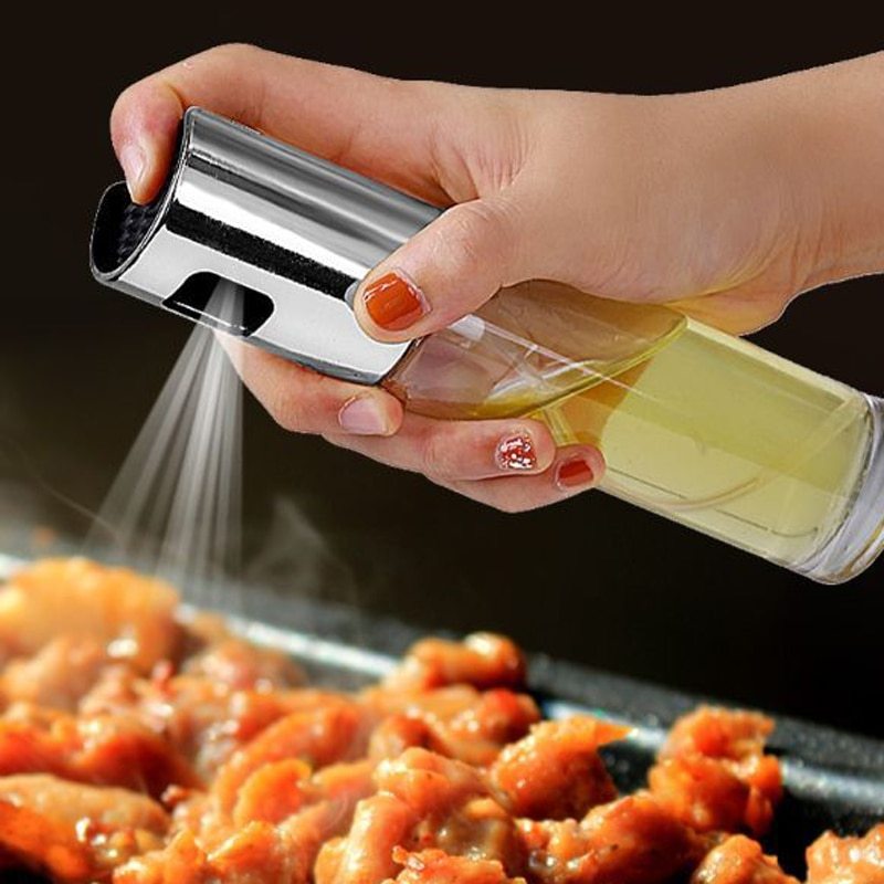 Shopi Vella BBQ oil spray bottle dispensing oil over grilled meat in kitchen storage setup