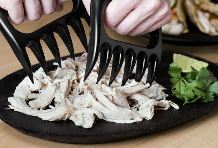Shopi Vella bear claw meat shredder for BBQ shredding cooked chicken on black plate with cilantro garnish