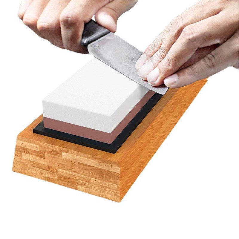 Shopi Vella kitchen knife being sharpened on the best sharpening stone for home use with wooden base