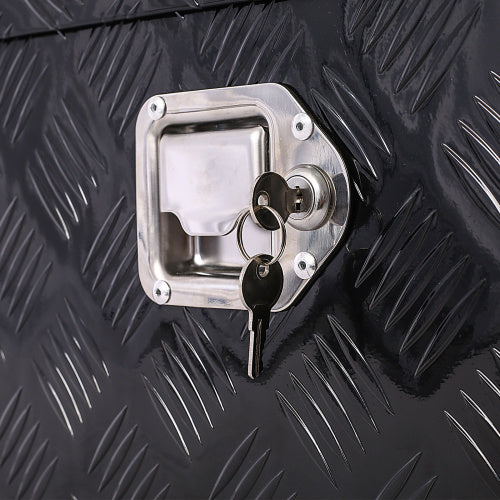Close-up of lock and keys on 30 inch aluminum truck tool box with textured black surface