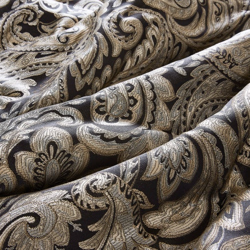 Close-up of intricate floral pattern on black king comforter set by Shopi Vella with textured fabric