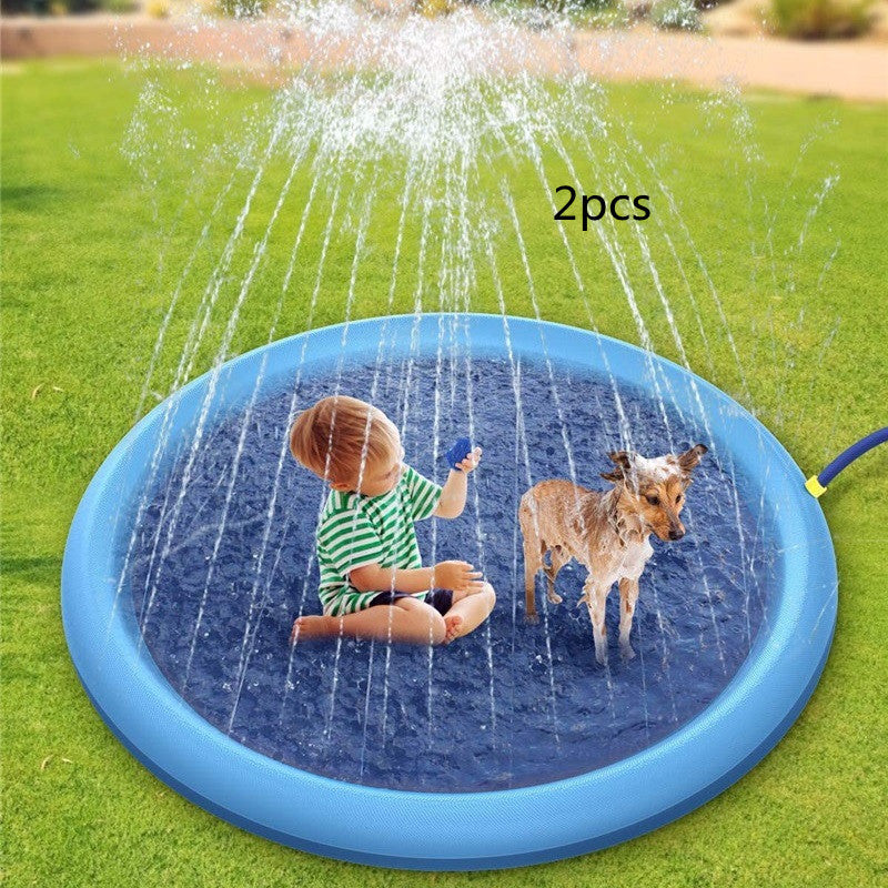 Blue non-slip splash pad for kids in use with child and dog playing on green grass outdoors