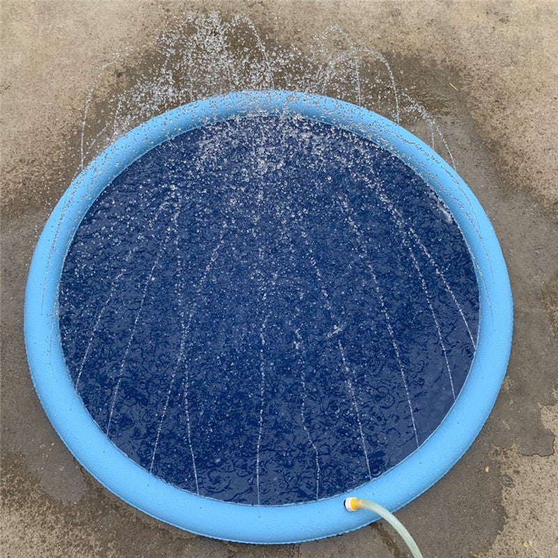 Blue non slip splash pad for kids with water spraying and circular inflatable edge on concrete