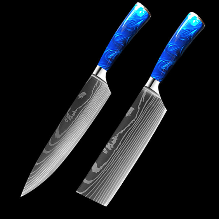 Set of kitchen knives featuring blue resin handle chef knife with patterned blades on black background