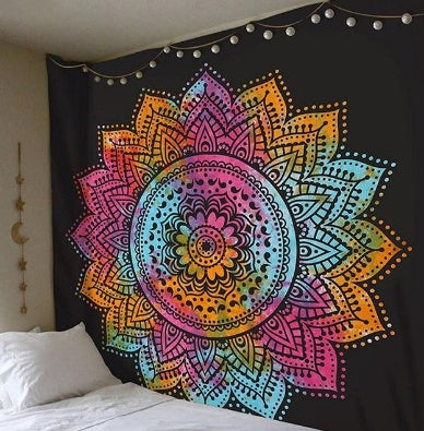 Boho tapestry wall hanging with vibrant multicolor mandala design on black background above bed