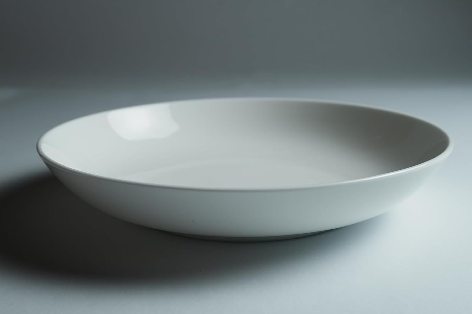 White shallow bowl from Shopi Vella bone china dinnerware set with smooth glossy finish
