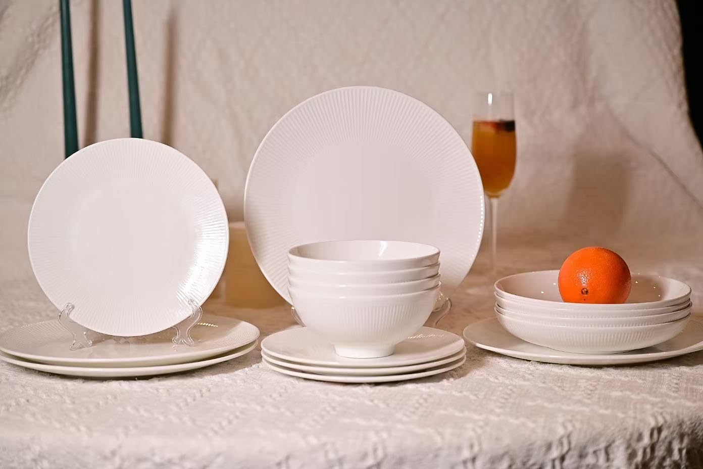 Shopi Vella bone china dinnerware set with white plates and bowls on a textured tablecloth