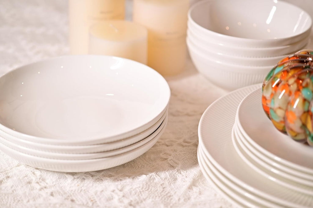 Shopi Vella elegant white bone china dinnerware set with plates and bowls on a textured tablecloth