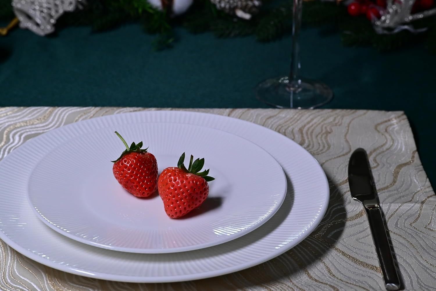 Shopi Vella bone china dinnerware set with two strawberries on white plates and silver knife on table