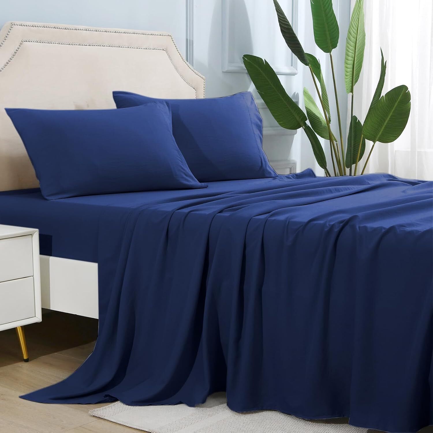 Shopi Vella navy blue microfiber bed sheet set on bed with pillows and modern decor