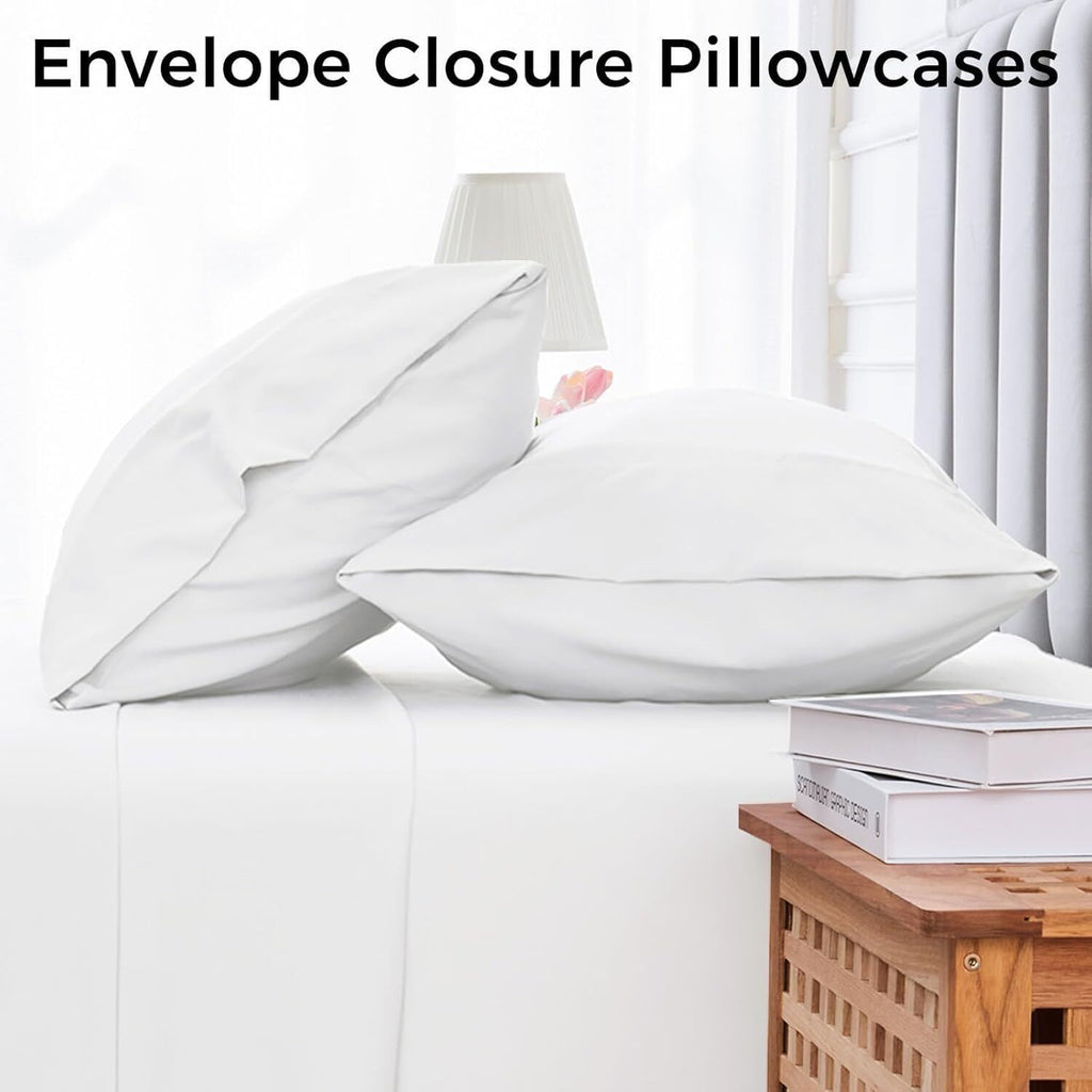 White microfiber bed sheet set with envelope closure pillowcases on a bed in a bright bedroom