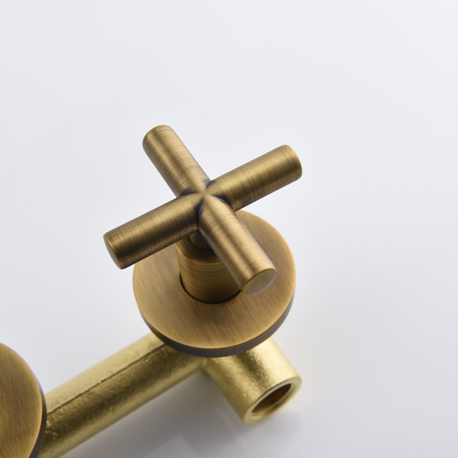 Shopi Vella wall mounted bathroom faucet with antique brass finish and cross handle design