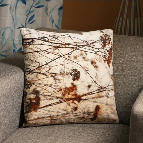 Shopi Vella 18 inch cotton pillow case with abstract brown and beige nature-inspired design on gray sofa