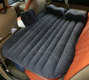 Black car inflatable bed with pillows set up on car backseat for comfortable travel rest