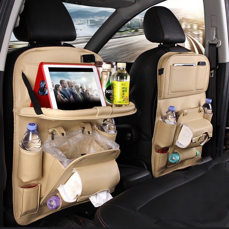 Shopi Vella beige car seat back storage bag with multiple pockets holding tablets, bottles, and tissues