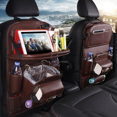 Shopi Vella brown leather car seat back storage bag with pockets holding tablet bottles and trash bag